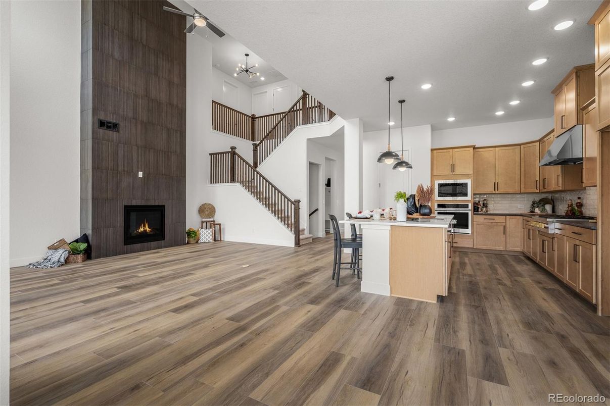 Dining room, Fireplace, Interior, Kitchen, Pendant Lights, Recessed Lighting, Stainless Steel Appliances, Wood Texture Flooring