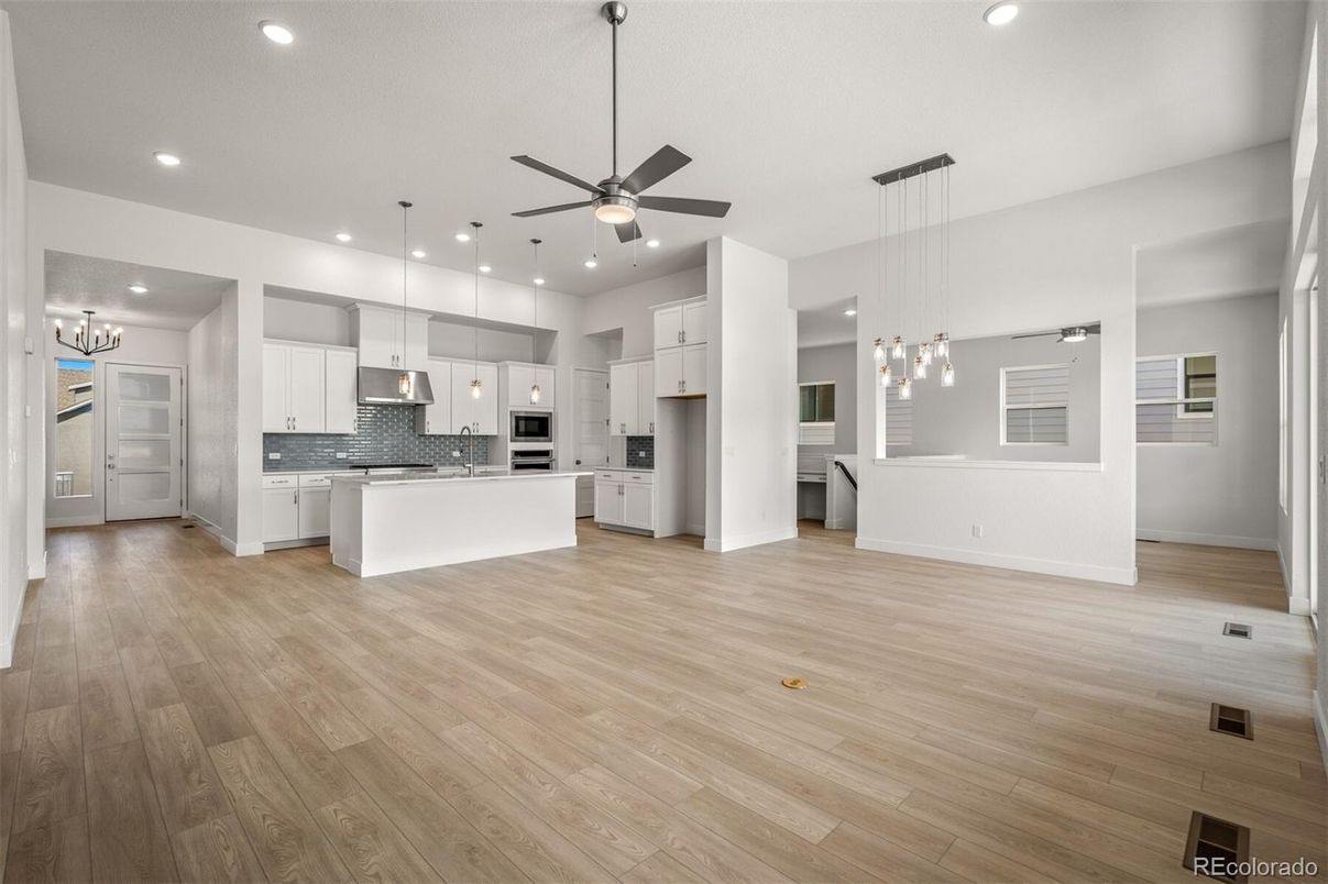 Empty room, Interior, Kitchen, Pendant Lights, Recessed Lighting, Stainless Steel Appliances, Wood Texture Flooring
