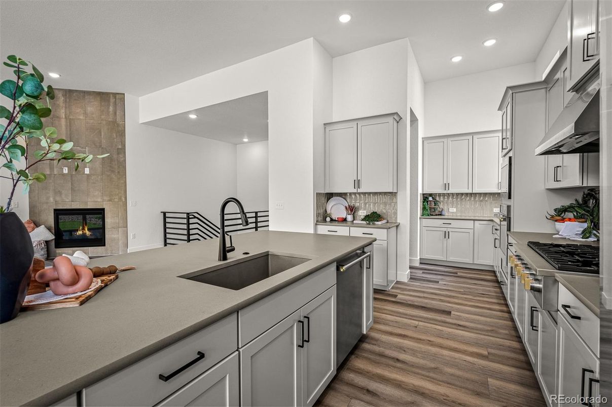 Fireplace, Interior, Kitchen, Recessed Lighting, Stainless Steel Appliances, Wood Texture Flooring