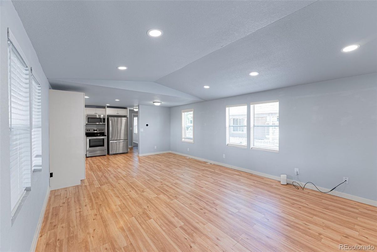 Empty room, Interior, Kitchen, Recessed Lighting, Stainless Steel Appliances, Wood Texture Flooring