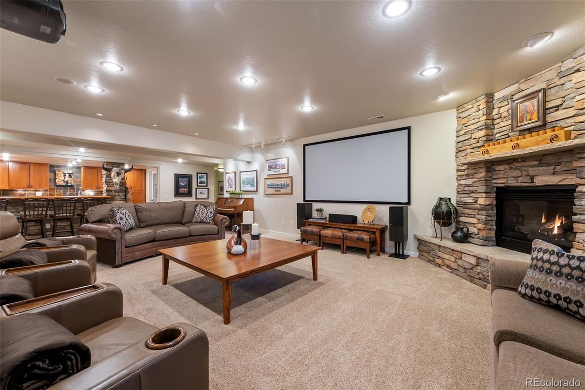 Fireplace, Interior, Living room, Projection Screen, Recessed Lighting, Stone Walls, Theatre Room