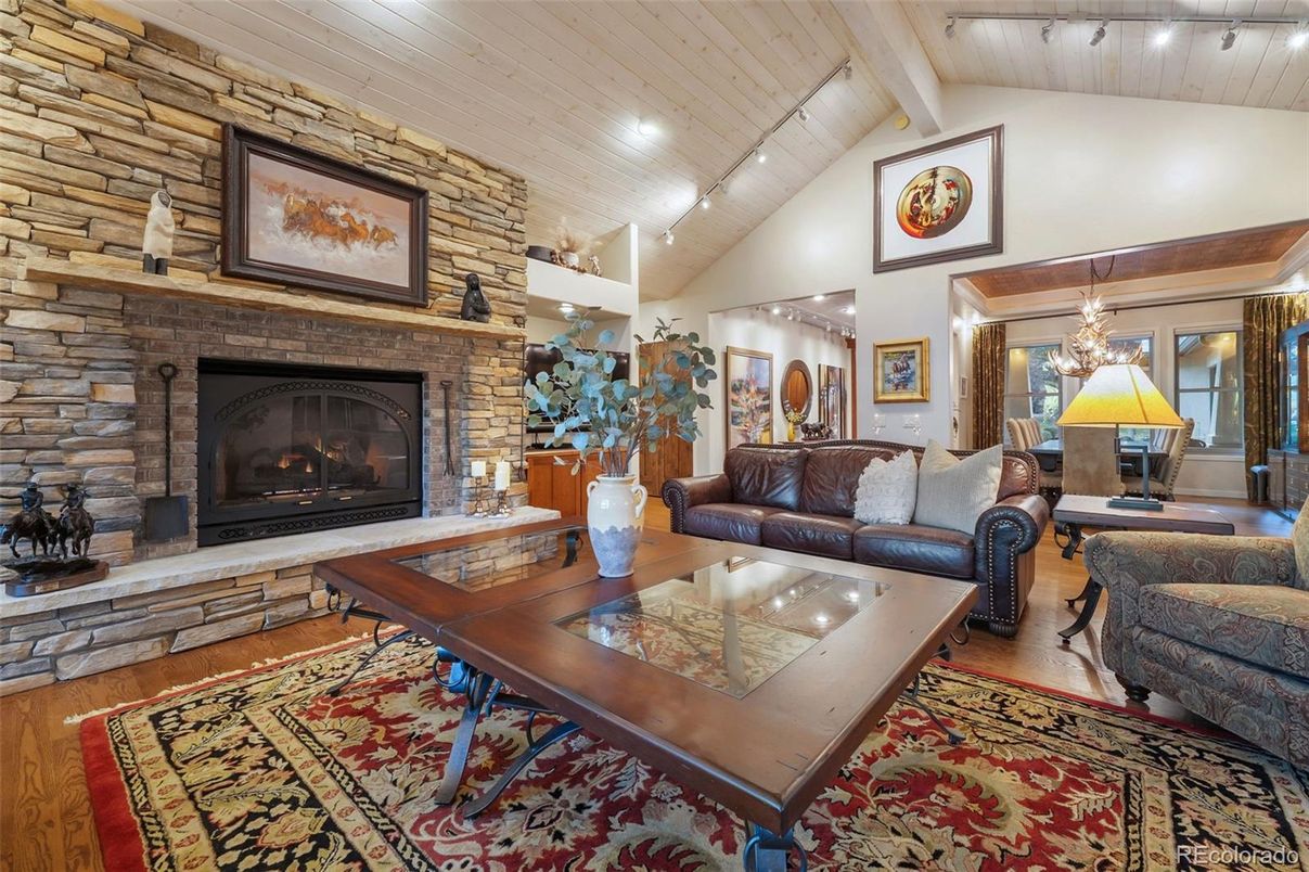 Chandelier, Dining room, Fireplace, Interior, Living room, Recessed Lighting, Stone Walls, Wooden Ceilings, Wood Texture Flooring