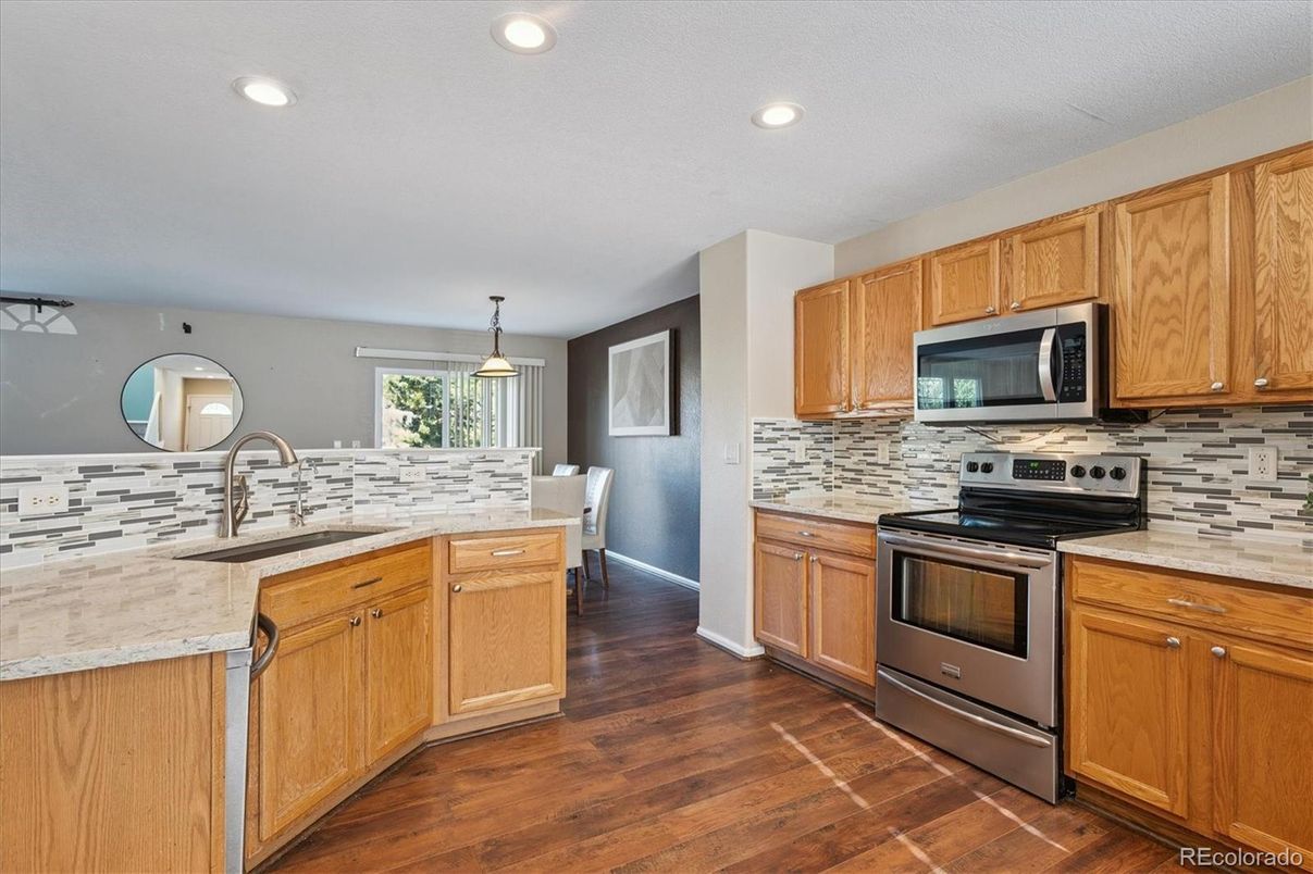 Dining room, Interior, Kitchen, Pendant Lights, Recessed Lighting, Stainless Steel Appliances, Wood Texture Flooring