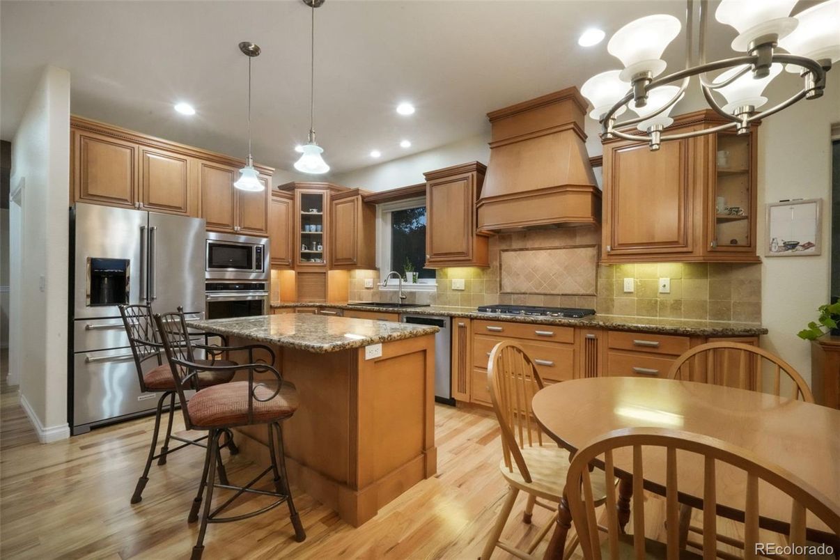 Chandelier, Dining room, Interior, Kitchen, Pendant Lights, Recessed Lighting, Stainless Steel Appliances, Wood Texture Flooring