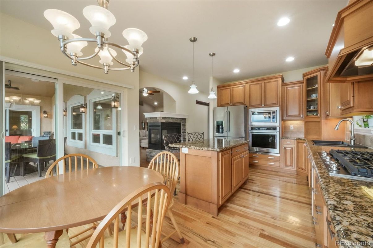 Chandelier, Dining room, Fireplace, Interior, Kitchen, Pendant Lights, Recessed Lighting, Stainless Steel Appliances, Wood Texture Flooring