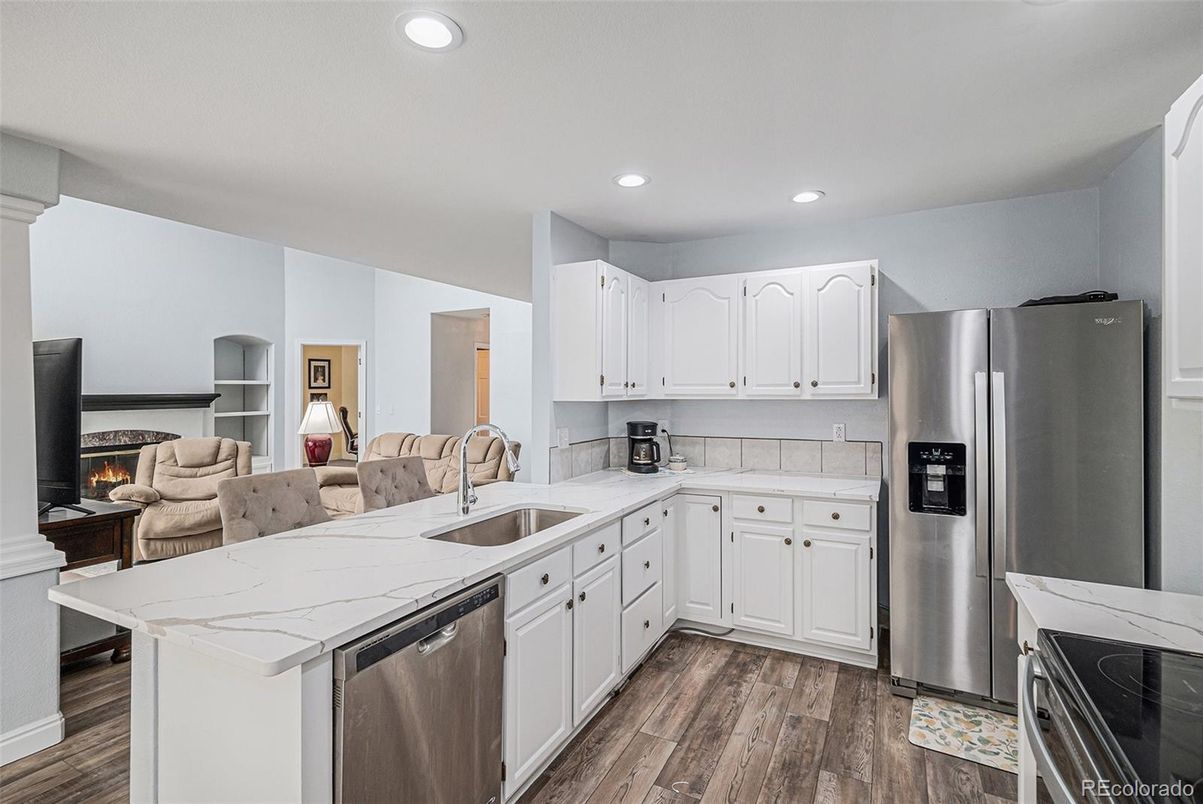 Fireplace, Interior, Kitchen, Recessed Lighting, Stainless Steel Appliances, Wood Texture Flooring