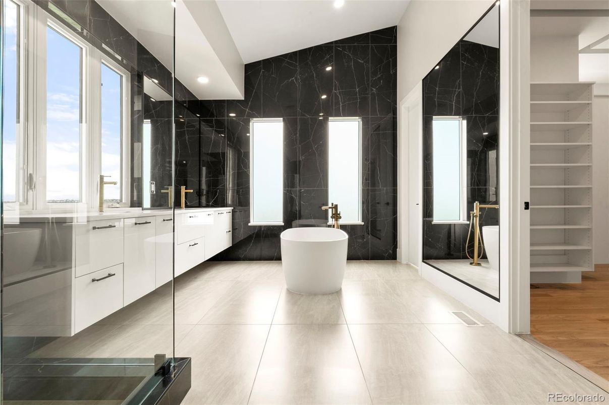 Bathroom, Dual Sink Vanities, Free Standing Baths, Glass Shower, Interior, Marble Walls, Recessed Lighting, Wood Texture Flooring