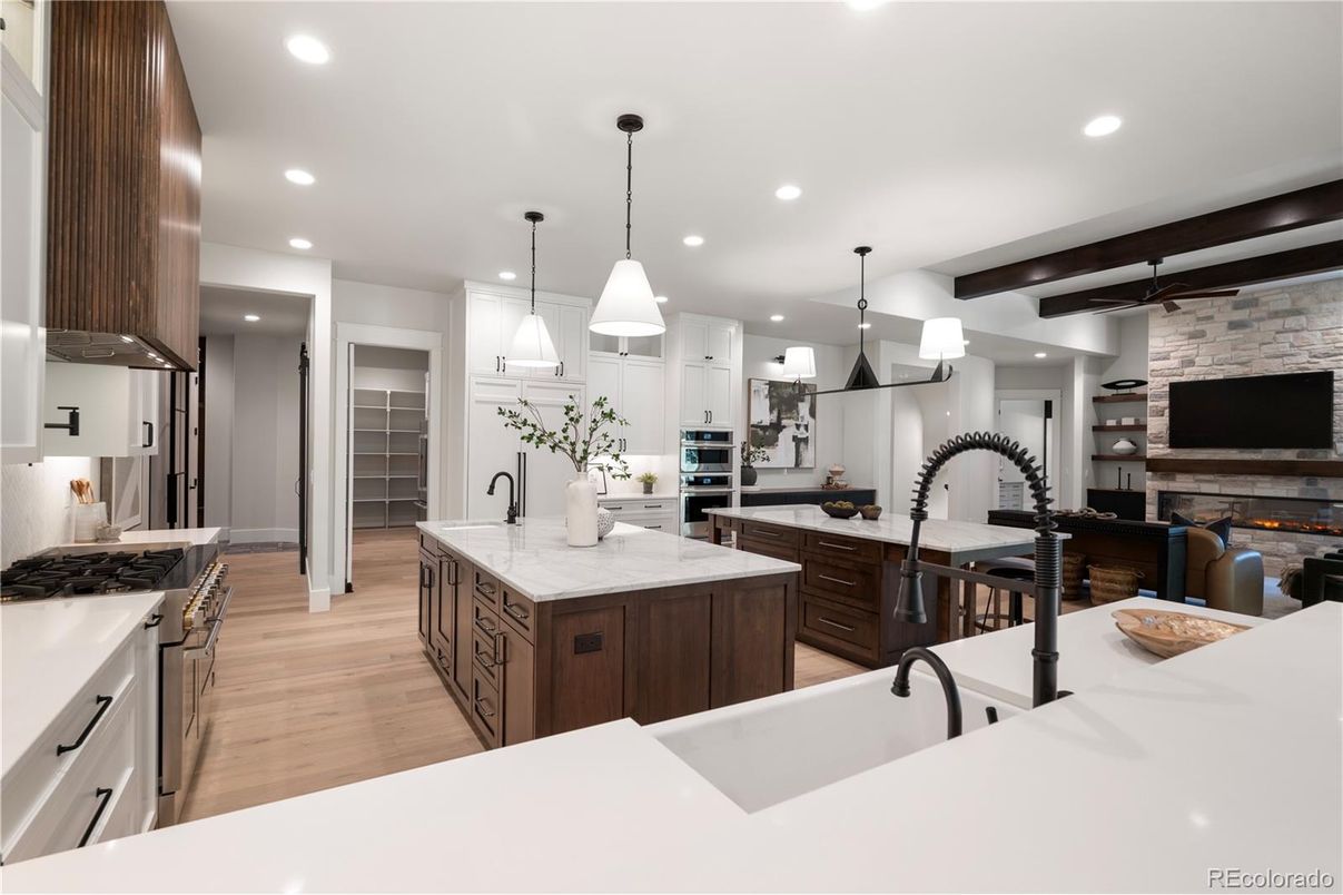 Fireplace, Interior, Kitchen, Pendant Lights, Recessed Lighting, Stainless Steel Appliances, Stone Walls, Wooden Beams, Wood Texture Flooring