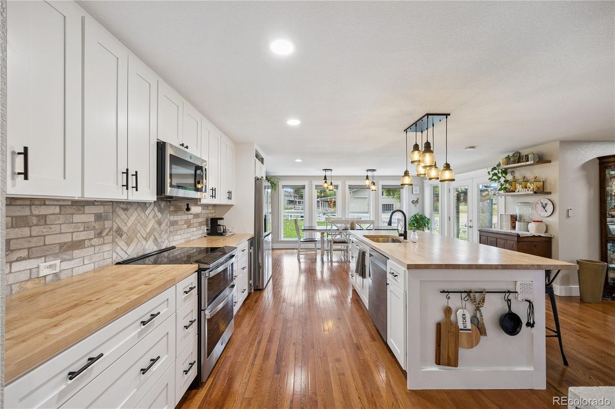 Dining room, Interior, Kitchen, Pendant Lights, Recessed Lighting, Stainless Steel Appliances, Wood Texture Flooring