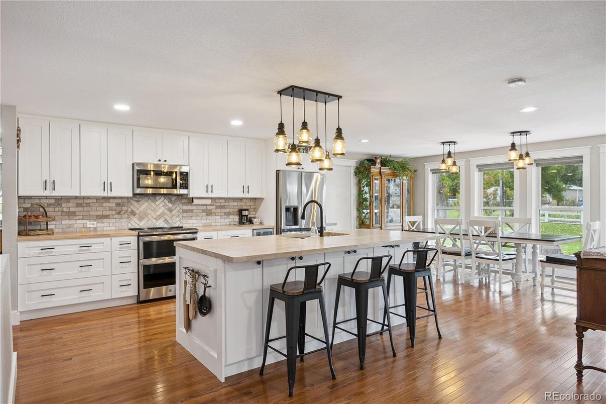 Dining room, Interior, Kitchen, Pendant Lights, Recessed Lighting, Stainless Steel Appliances, Wood Texture Flooring