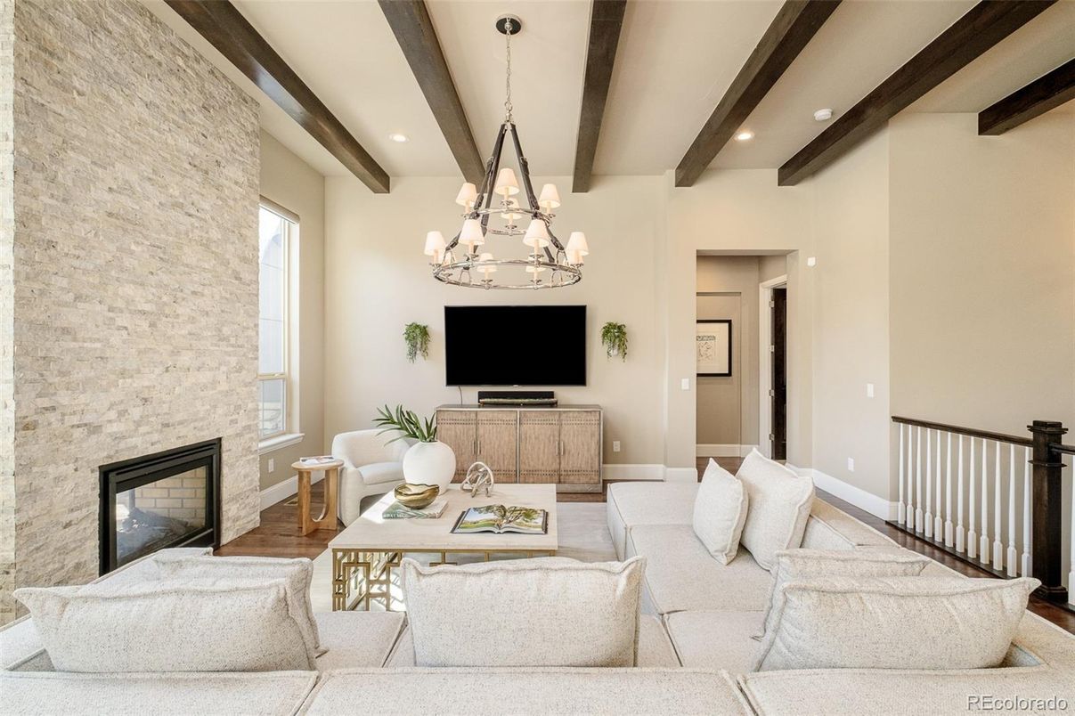 Chandelier, Fireplace, Interior, Living room, Recessed Lighting, Stone Walls, Wooden Beams, Wood Texture Flooring