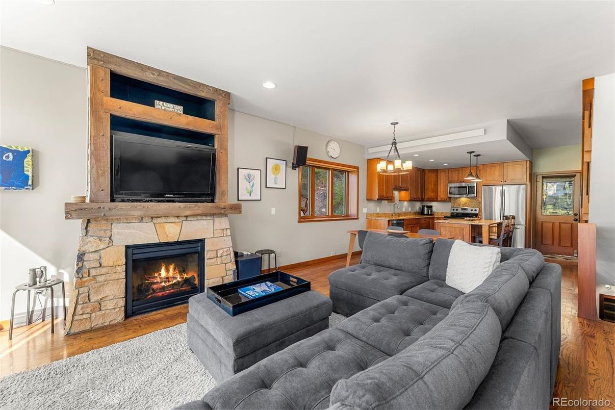 Dining room, Fireplace, Interior, Kitchen, Living room, Pendant Lights, Recessed Lighting, Stainless Steel Appliances, Wood Texture Flooring