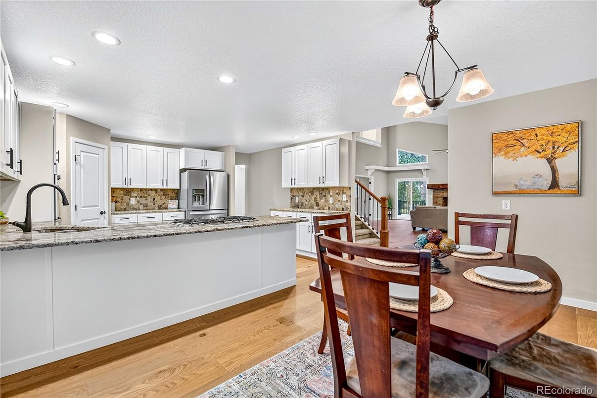 Dining room, Interior, Kitchen, Pendant Lights, Recessed Lighting, Stainless Steel Appliances, Wood Texture Flooring