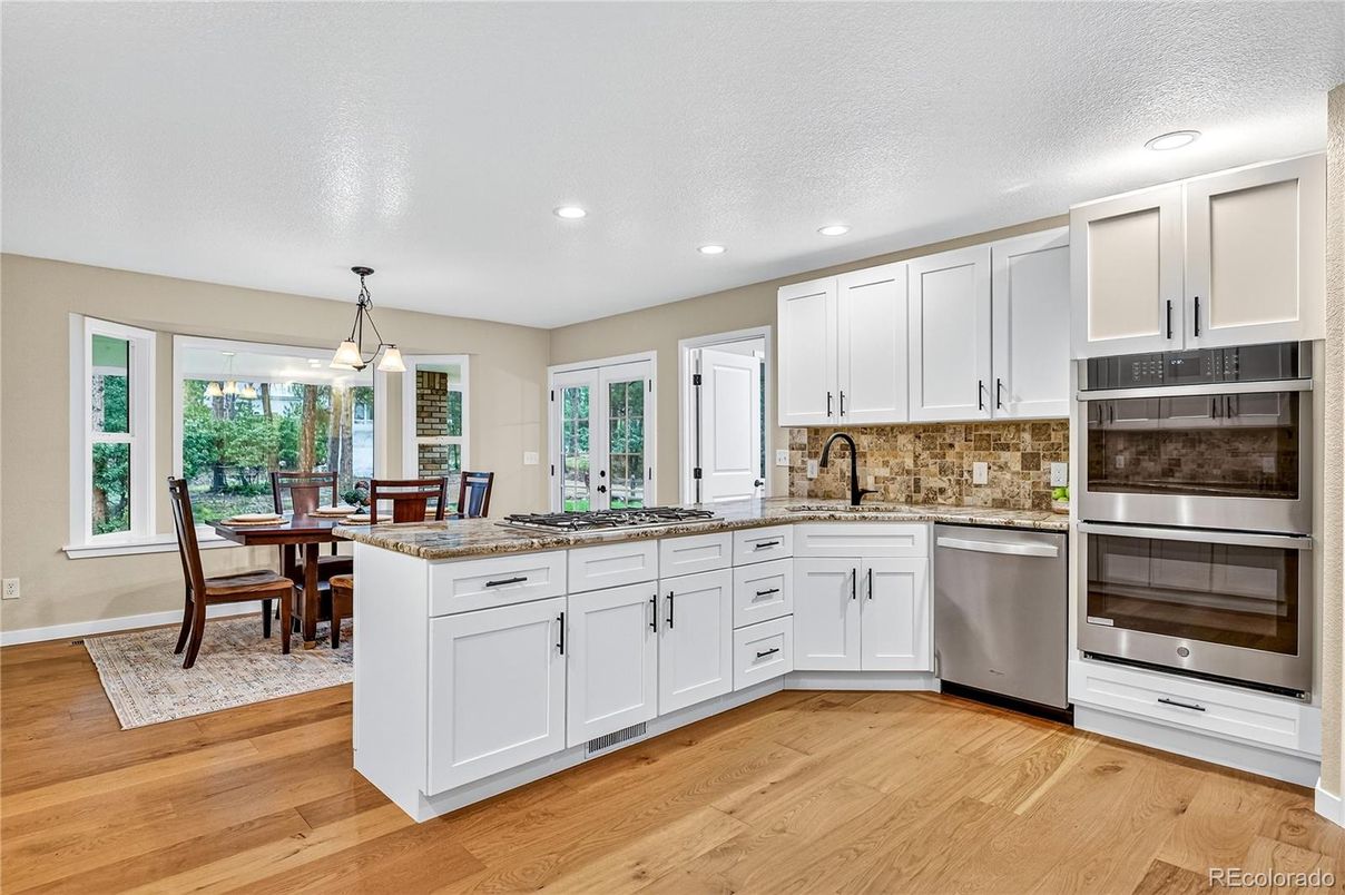 Dining room, Interior, Kitchen, Pendant Lights, Recessed Lighting, Stainless Steel Appliances, Wood Texture Flooring