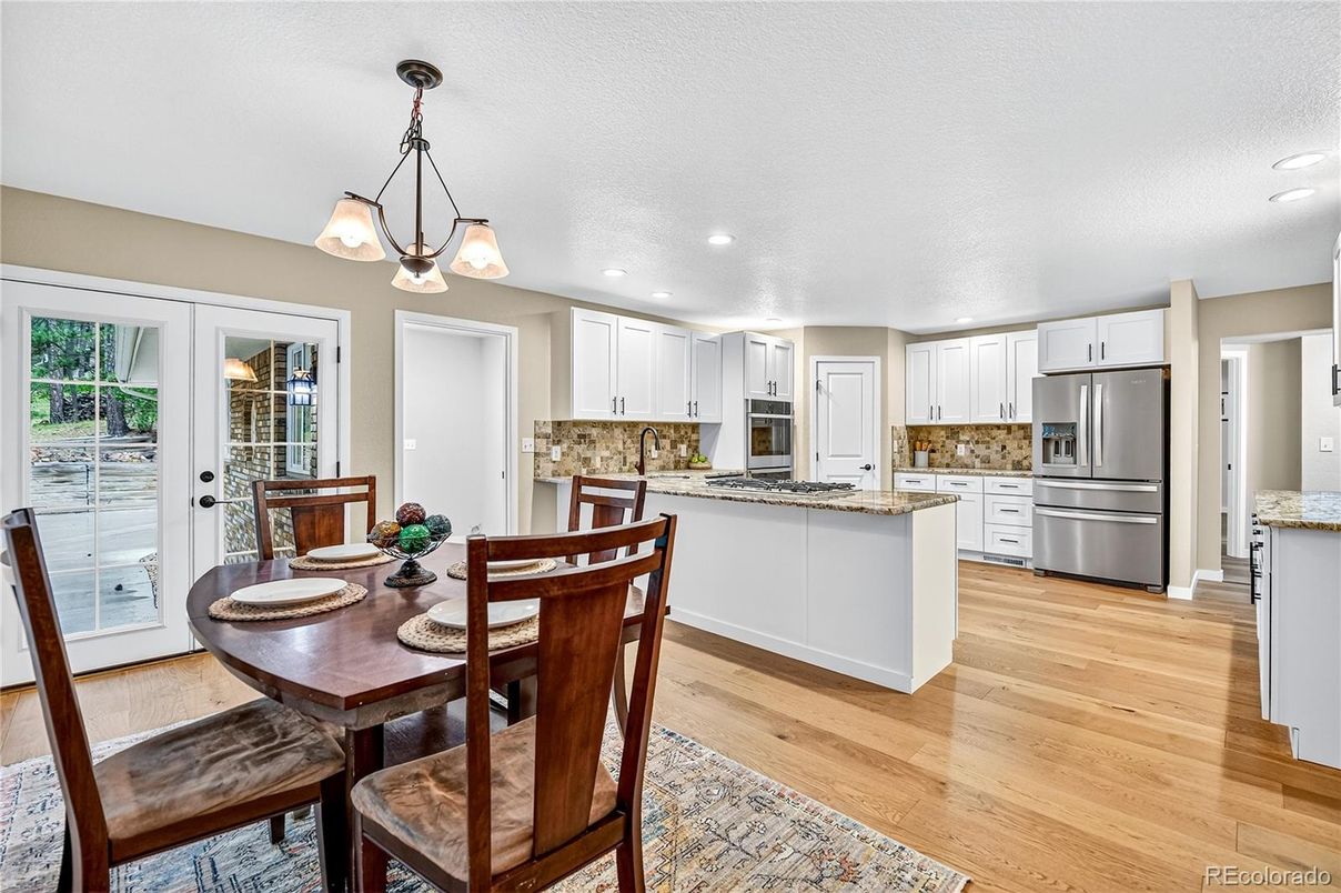 Dining room, Interior, Kitchen, Pendant Lights, Recessed Lighting, Stainless Steel Appliances, Wood Texture Flooring