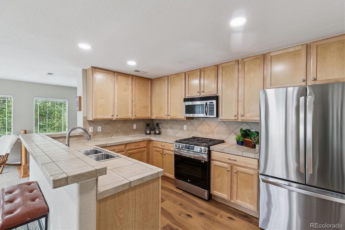 Interior, Kitchen, Recessed Lighting, Stainless Steel Appliances, Tile Countertops, Wood Texture Flooring