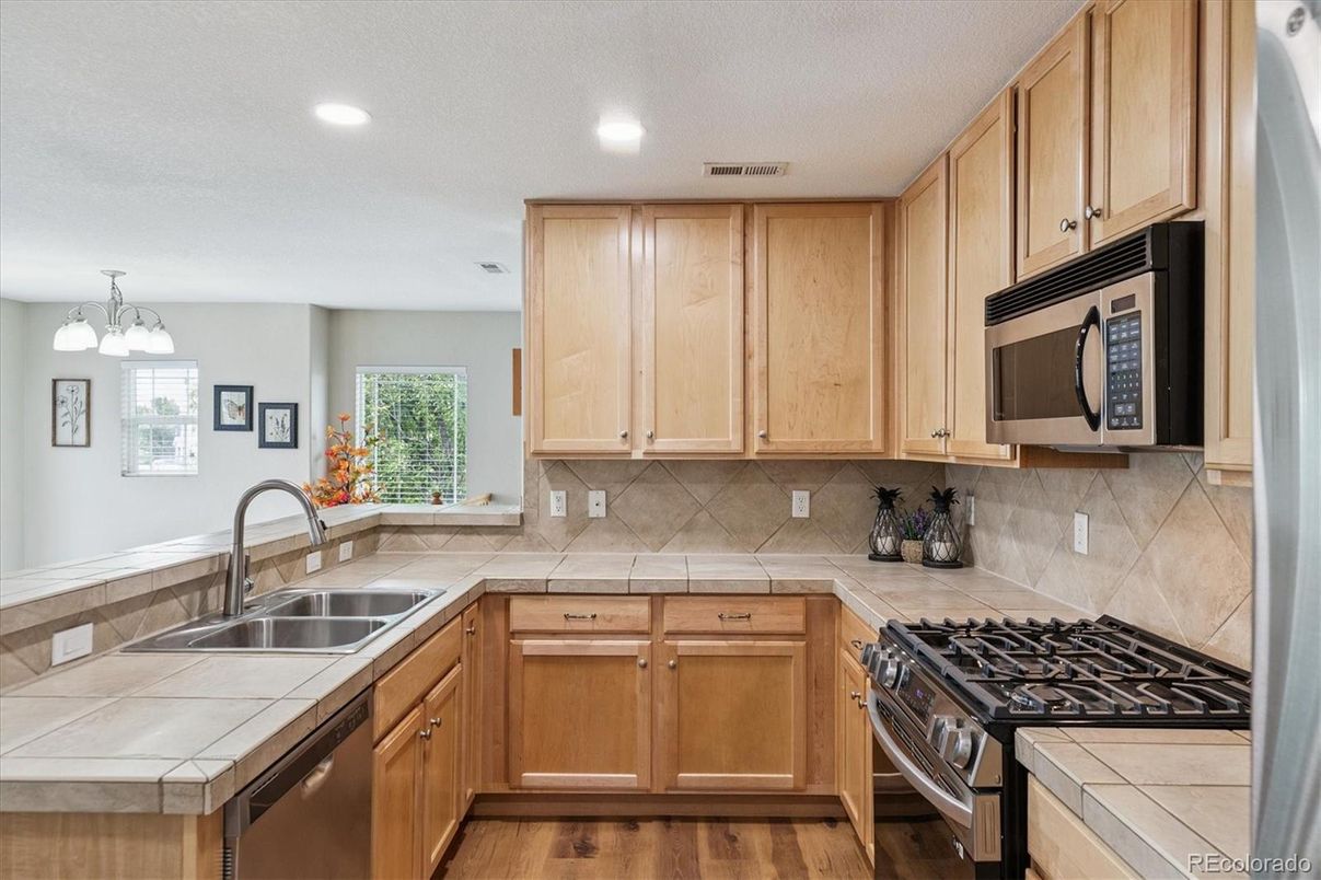Interior, Kitchen, Recessed Lighting, Tile Countertops, Wood Texture Flooring