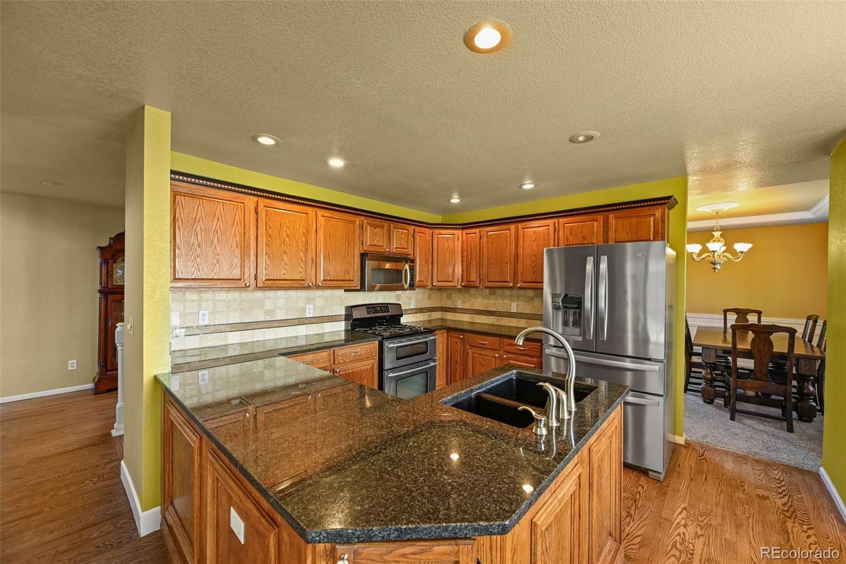 Chandelier, Dining room, Interior, Kitchen, Recessed Lighting, Stainless Steel Appliances, Wood Texture Flooring