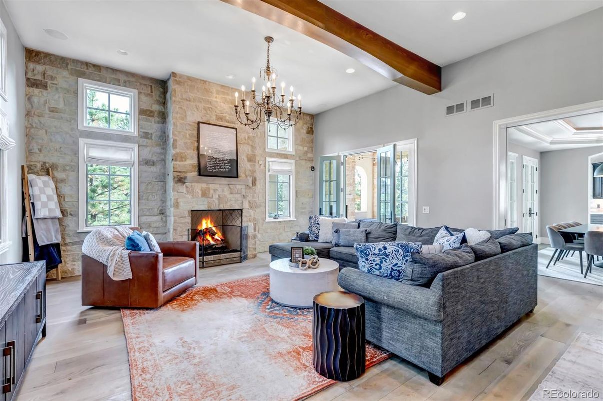 Chandelier, Dining room, Fireplace, Interior, Living room, Recessed Lighting, Stone Walls, Wooden Beams, Wood Texture Flooring