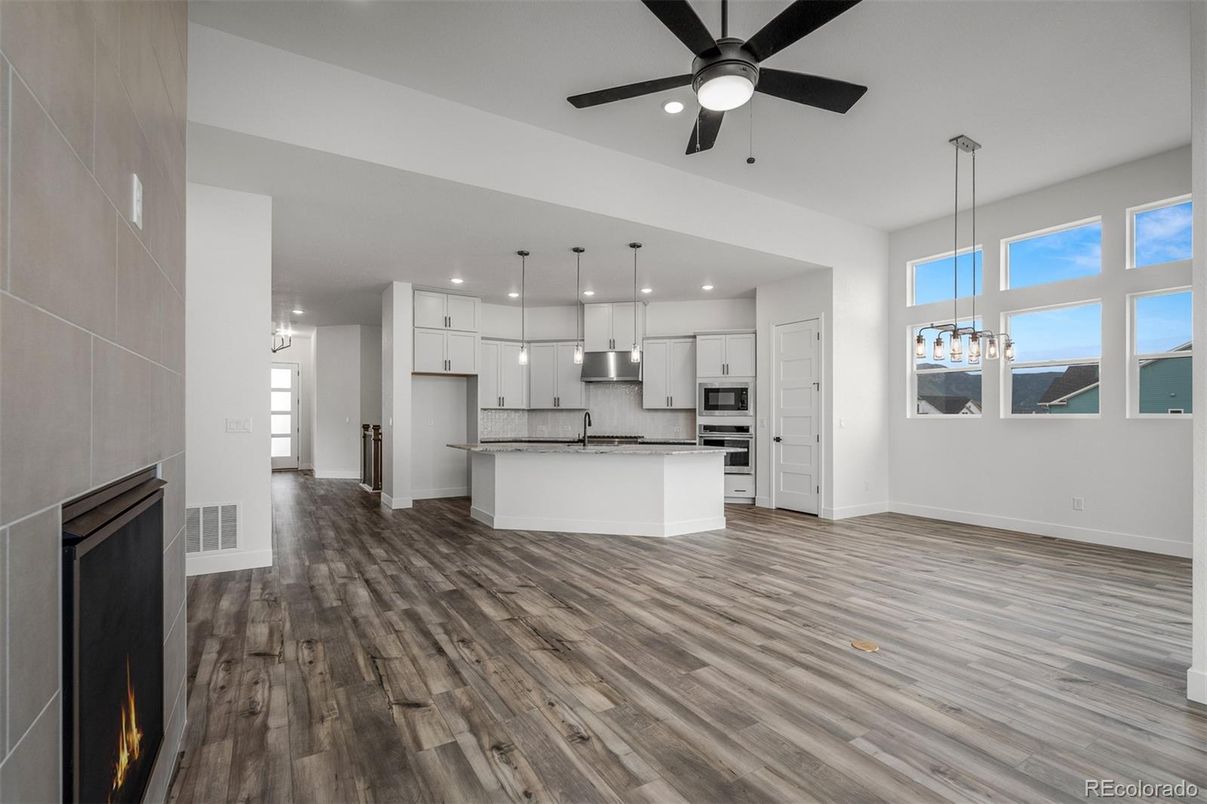 Chandelier, Empty room, Interior, Kitchen, Pendant Lights, Recessed Lighting, Stainless Steel Appliances, Wood Texture Flooring