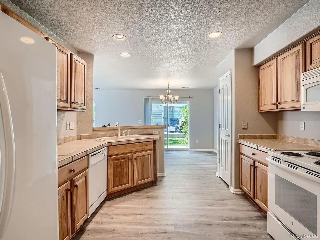 Chandelier, Interior, Kitchen, Recessed Lighting, Tile Countertops, Wood Texture Flooring