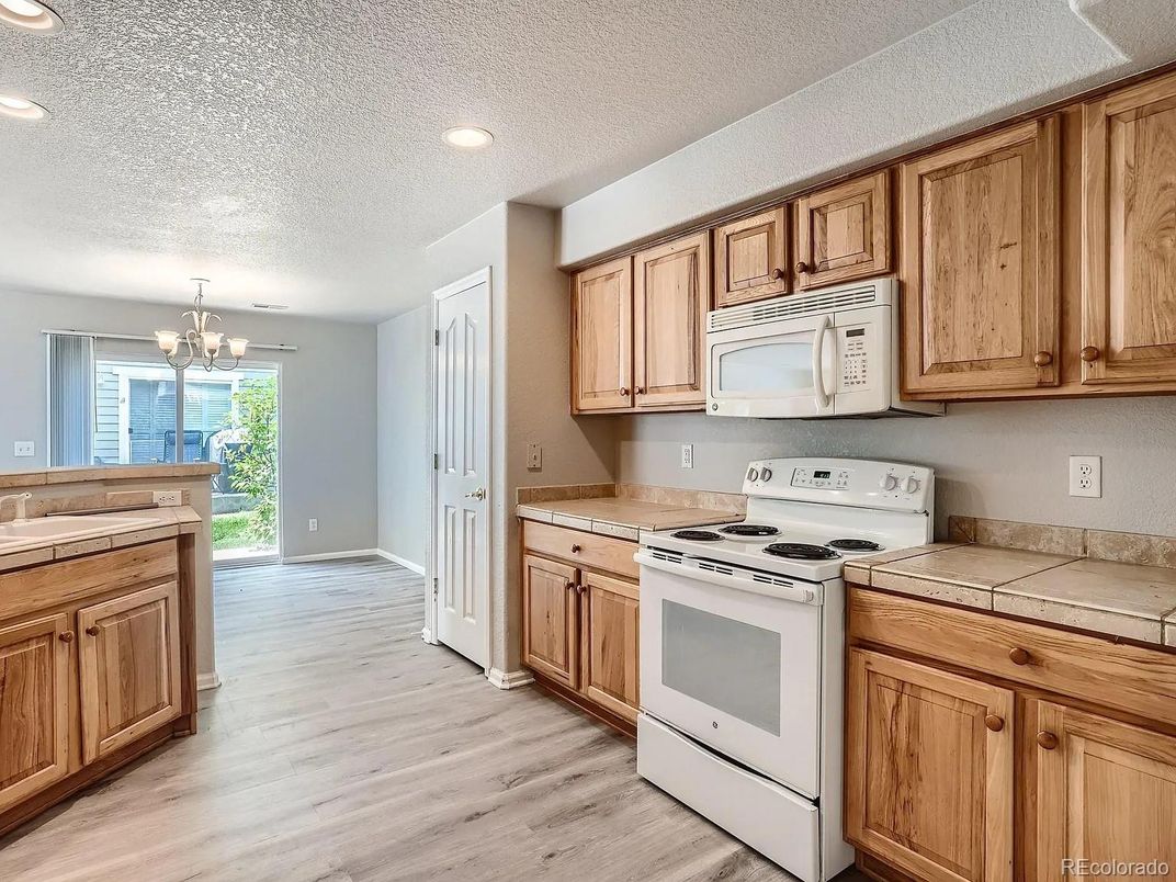 Chandelier, Interior, Kitchen, Recessed Lighting, Tile Countertops, Wood Texture Flooring