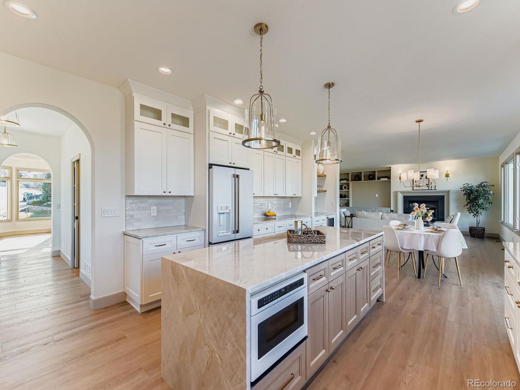 Chandelier, Dining room, Fireplace, Interior, Kitchen, Living room, Pendant Lights, Recessed Lighting, Stainless Steel Appliances, Wood Texture Flooring