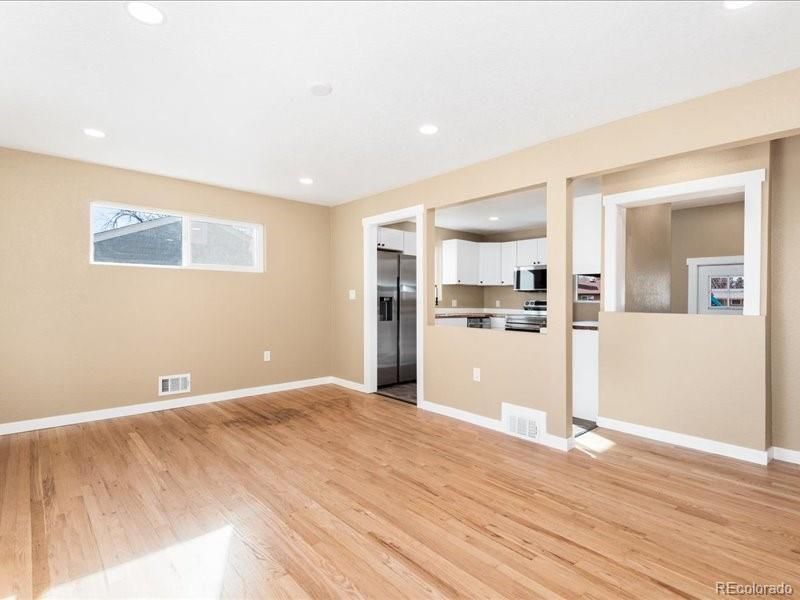 Empty room, Interior, Kitchen, Recessed Lighting, Stainless Steel Appliances, Wood Texture Flooring
