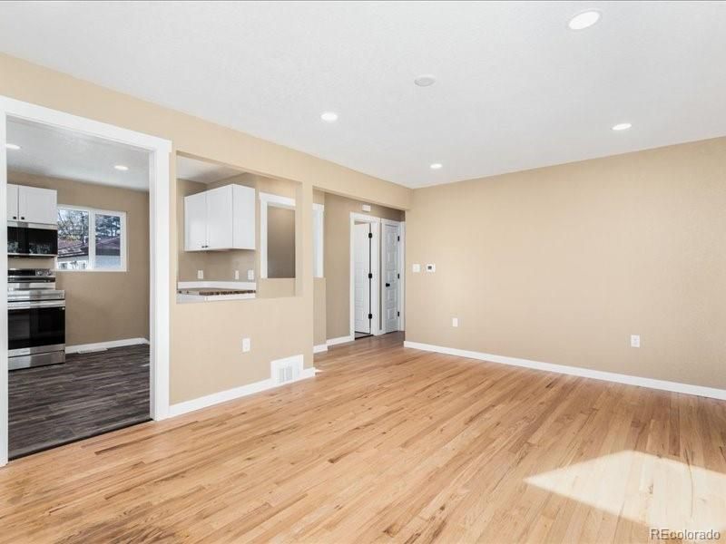 Empty room, Interior, Kitchen, Recessed Lighting, Stainless Steel Appliances, Wood Texture Flooring