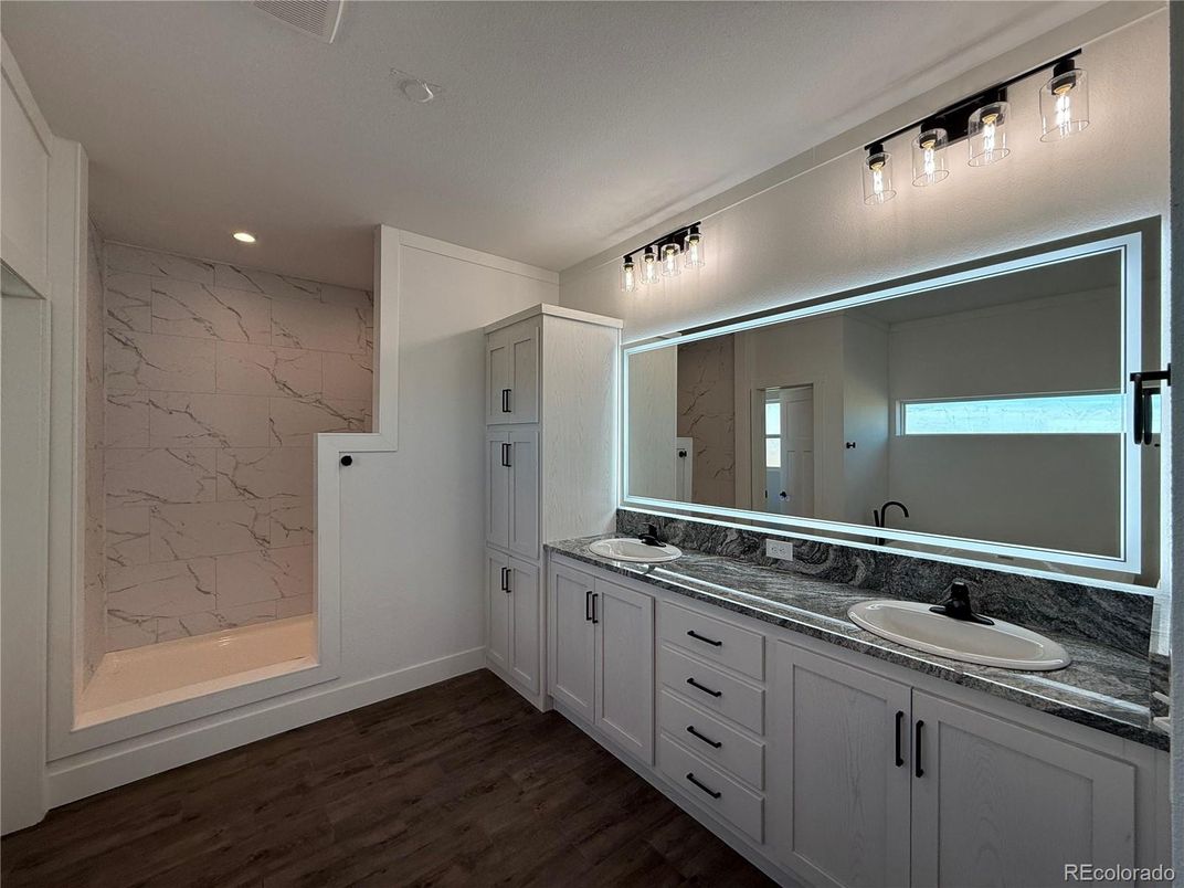 Bathroom, Dual Sink Vanities, Interior, Marble Walls, Recessed Lighting, Wood Texture Flooring