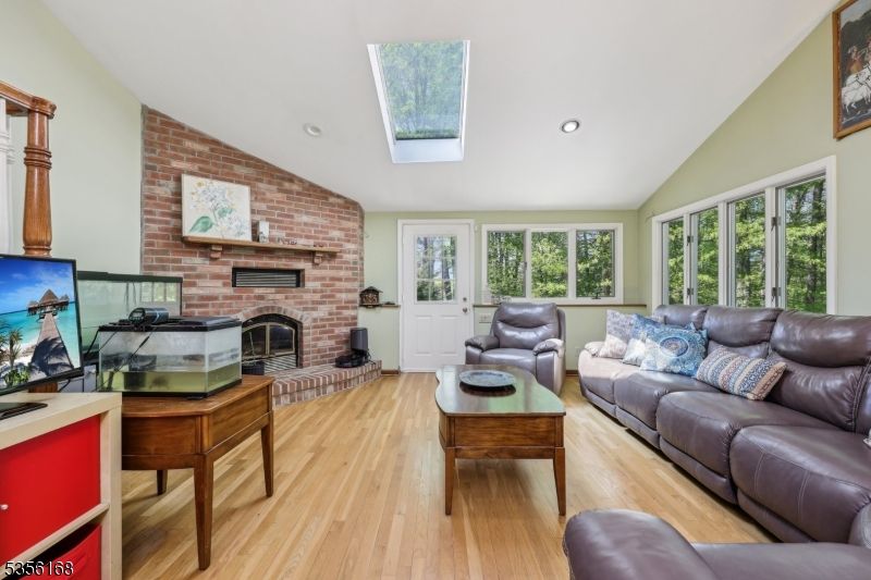 Fireplace, Interior, Living room, Recessed Lighting, Stone Walls, Wood Texture Flooring