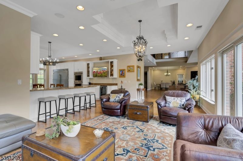 Chandelier, Dining room, Interior, Kitchen, Living room, Pendant Lights, Recessed Lighting, Stainless Steel Appliances, Wood Texture Flooring