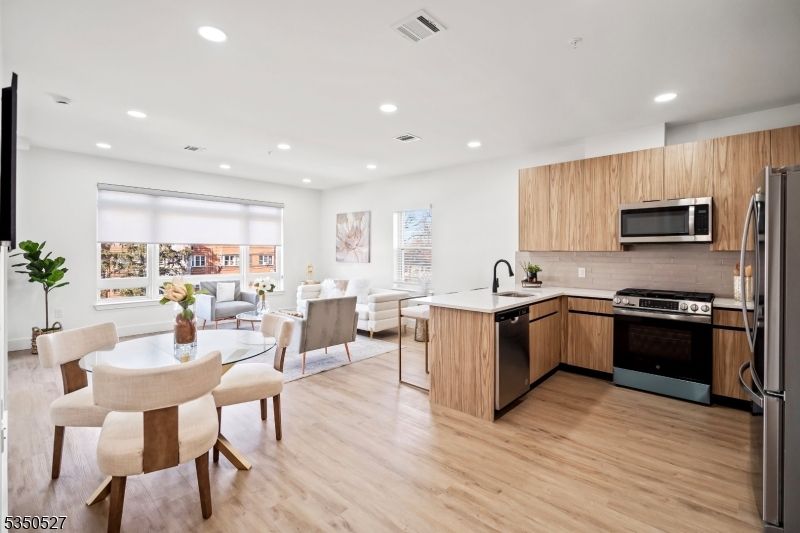 Dining room, Interior, Kitchen, Living room, Recessed Lighting, Stainless Steel Appliances, Wood Texture Flooring
