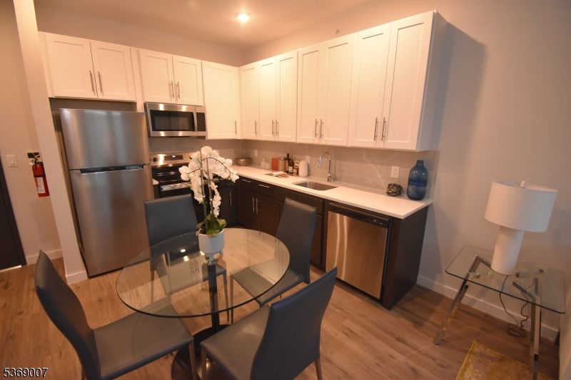 Dining room, Interior, Kitchen, Recessed Lighting, Stainless Steel Appliances, Wood Texture Flooring