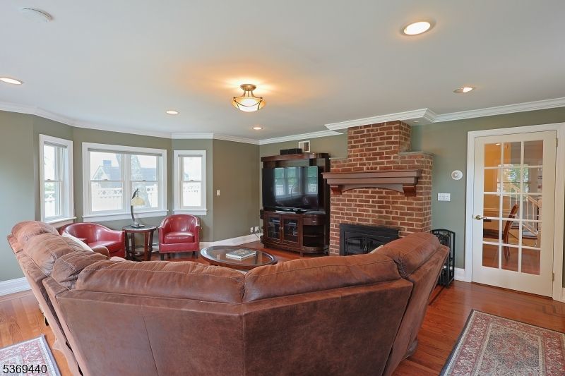 Fireplace, Interior, Living room, Recessed Lighting, Stone Walls, Wood Texture Flooring