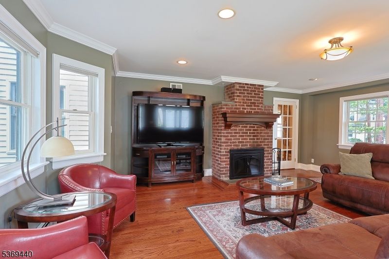 Fireplace, Interior, Living room, Recessed Lighting, Stone Walls, Wood Texture Flooring