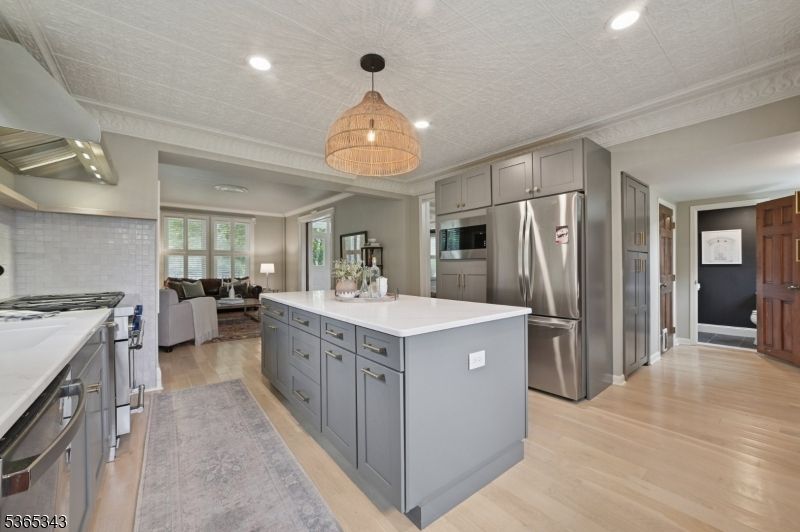 Chandelier, Interior, Kitchen, Living room, Recessed Lighting, Stainless Steel Appliances, Wood Texture Flooring