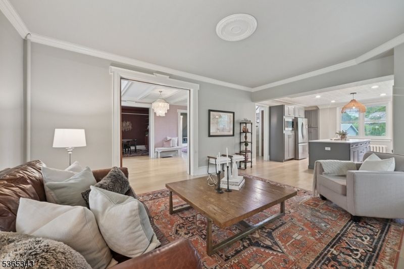 Chandelier, Dining room, Interior, Kitchen, Living room, Pendant Lights, Recessed Lighting, Stainless Steel Appliances, Wood Texture Flooring