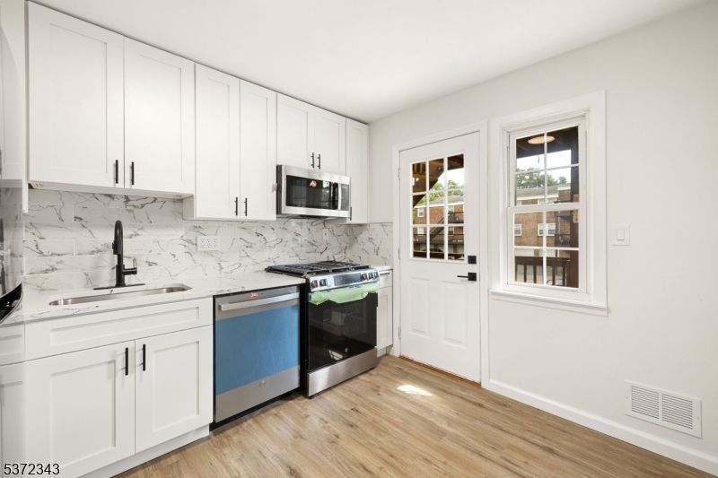Interior, Kitchen, Marble Walls, Stainless Steel Appliances, Wood Texture Flooring