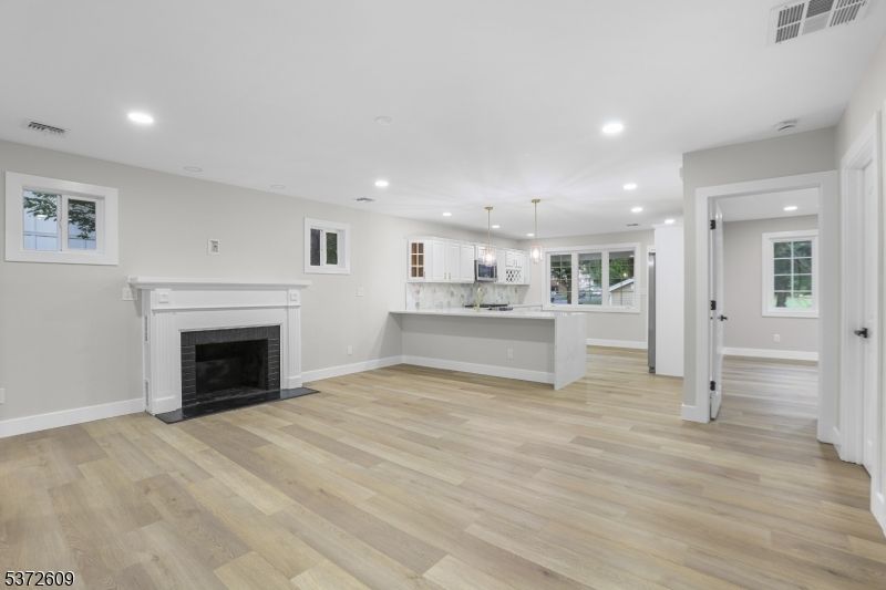 Empty room, Fireplace, Interior, Kitchen, Pendant Lights, Recessed Lighting, Wood Texture Flooring