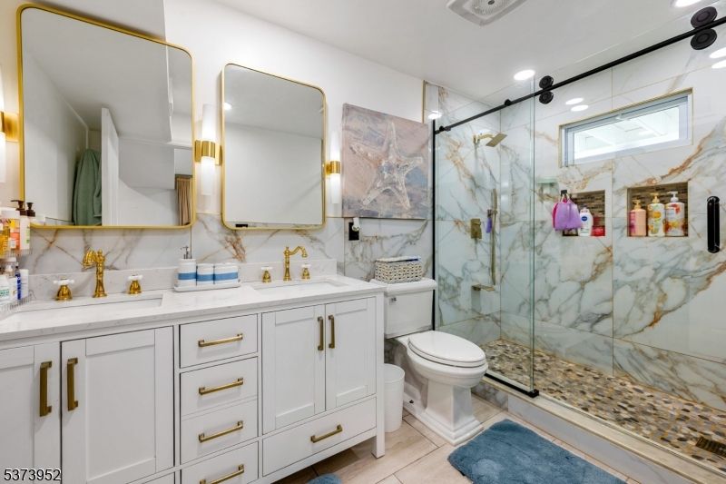 Bathroom, Dual Sink Vanities, Glass Shower, Interior, Marble Walls, Recessed Lighting
