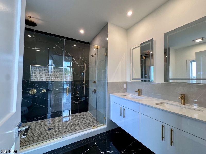 Bathroom, Dual Sink Vanities, Glass Shower, Interior, Marble Walls, Recessed Lighting