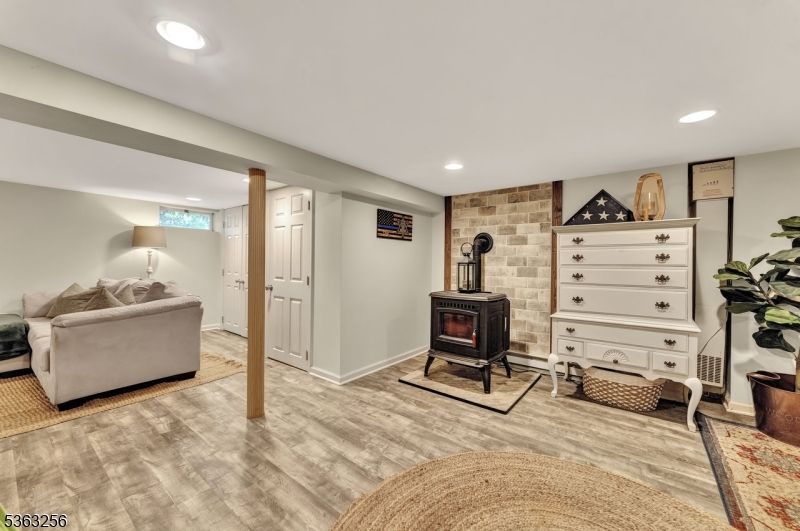Fireplace, Interior, Living room, Recessed Lighting, Stone Walls, Wood Texture Flooring