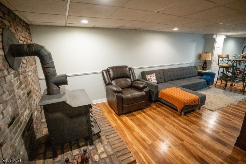Fireplace, Interior, Living room, Recessed Lighting, Stone Walls, Wood Texture Flooring