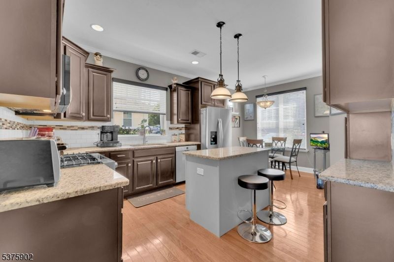 Dining room, Interior, Kitchen, Pendant Lights, Recessed Lighting, Stainless Steel Appliances, Wood Texture Flooring