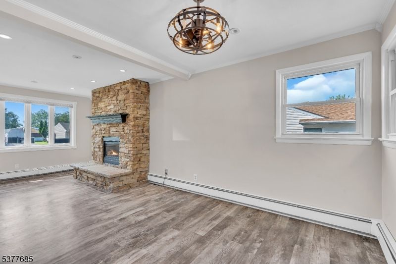 Chandelier, Empty room, Fireplace, Interior, Recessed Lighting, Stone Walls, Wood Texture Flooring