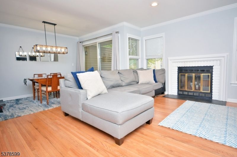 Chandelier, Dining room, Fireplace, Interior, Living room, Recessed Lighting, Wood Texture Flooring