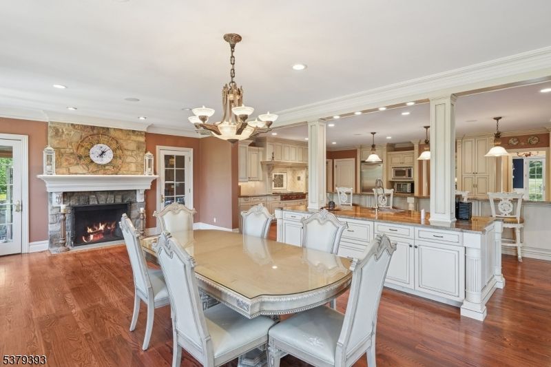 Chandelier, Dining room, Fireplace, Interior, Kitchen, Pendant Lights, Recessed Lighting, Stone Walls, Wood Texture Flooring