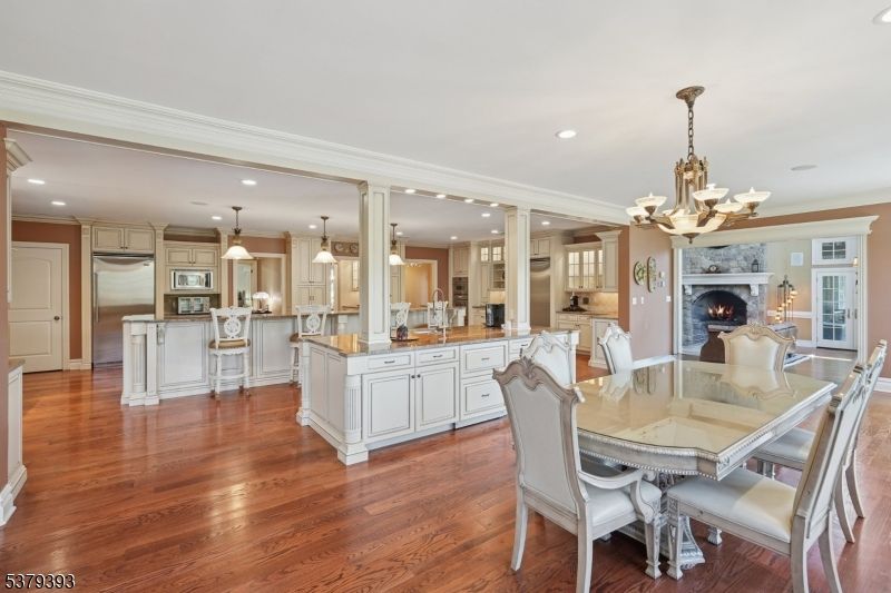 Chandelier, Dining room, Fireplace, Interior, Kitchen, Pendant Lights, Recessed Lighting, Stainless Steel Appliances, Wood Texture Flooring