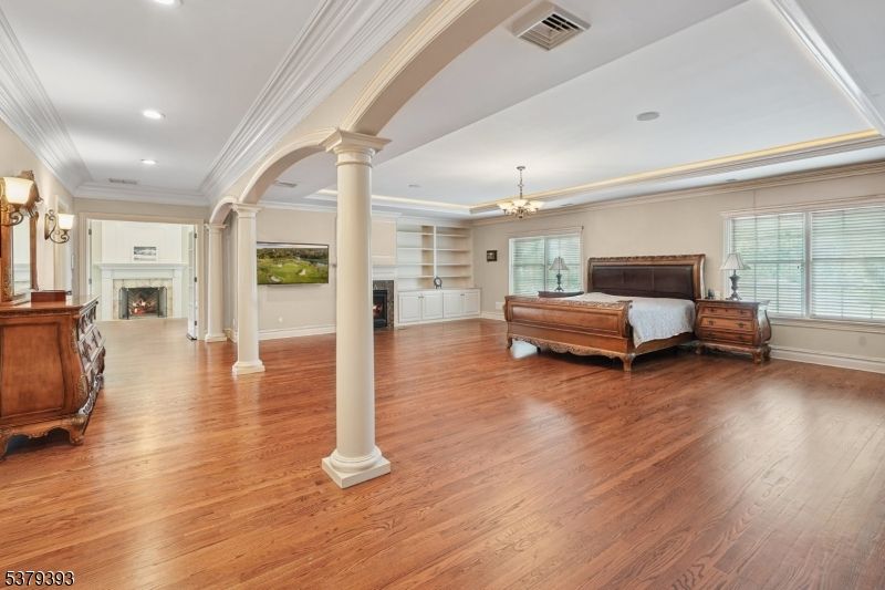 Bedroom, Chandelier, Fireplace, Interior, Recessed Lighting, Wood Texture Flooring
